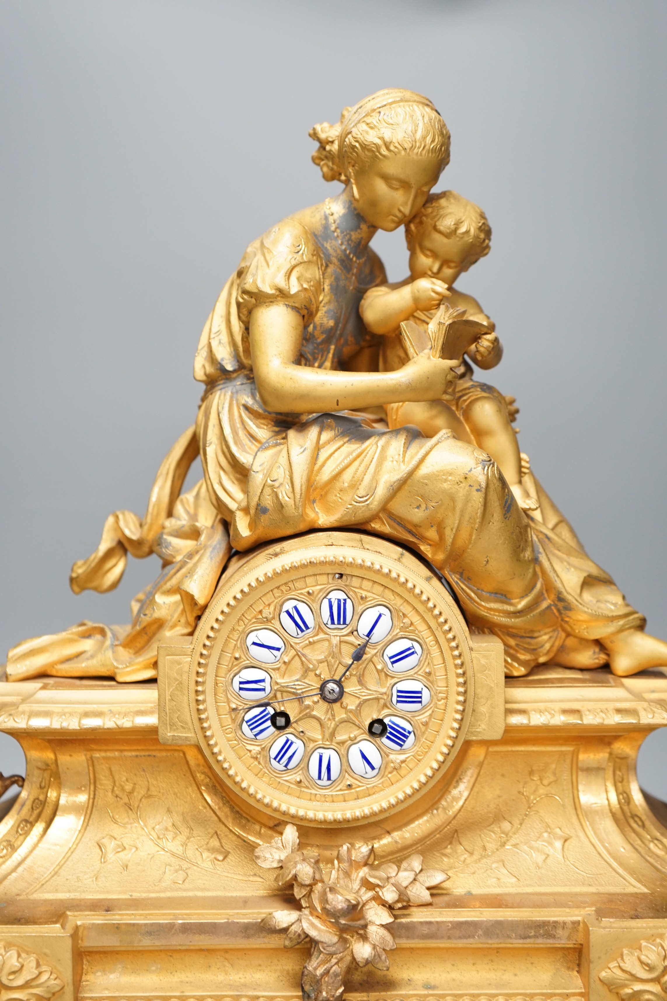 A 19th century 'Mother and child' French ormolu clock on plinth base, 44cm high